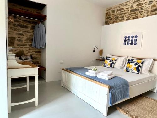a bedroom with a bed and a desk at Katrani studios in Symi