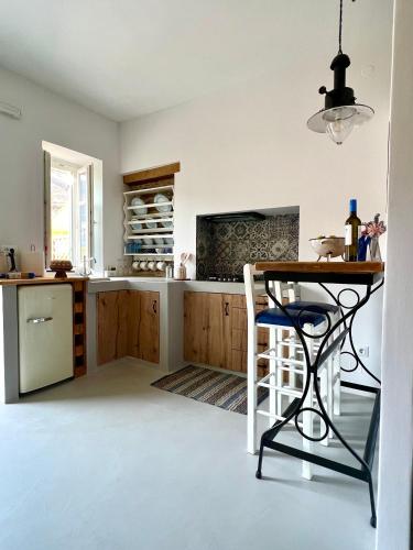 a kitchen with a table and a chair in it at Katrani studios in Symi