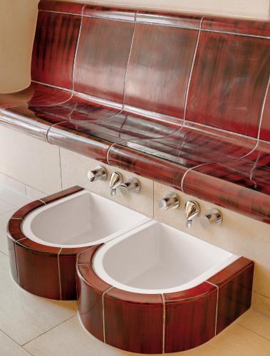 a bathroom with a sink and a red wall at Pfalzhotel Asselheim in Asselheim