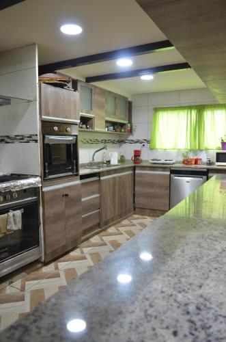 a large kitchen with stainless steel appliances and a counter at Caballo de Fuego in Ushuaia