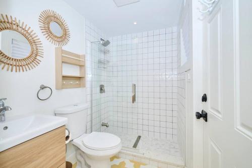 a bathroom with a toilet and a sink and a shower at Beachside Abode Crystal Beach in Fort Erie