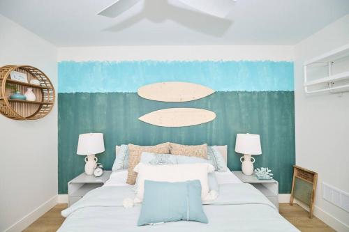 a bedroom with a large white bed with two lamps at Beachside Abode Crystal Beach in Fort Erie