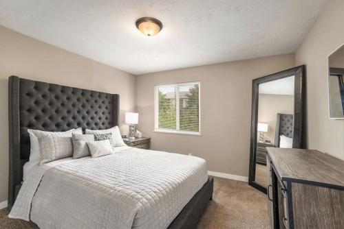 une chambre avec un grand lit et un miroir dans l'établissement Urban Chateau Downtown Retreat, à Grand Rapids