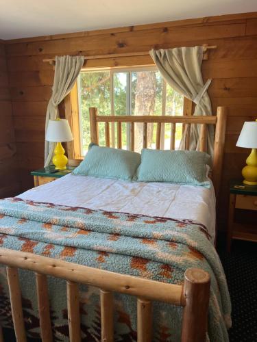 a bedroom with a wooden bed with a window at Deer Harbor Inn in Deer Harbor