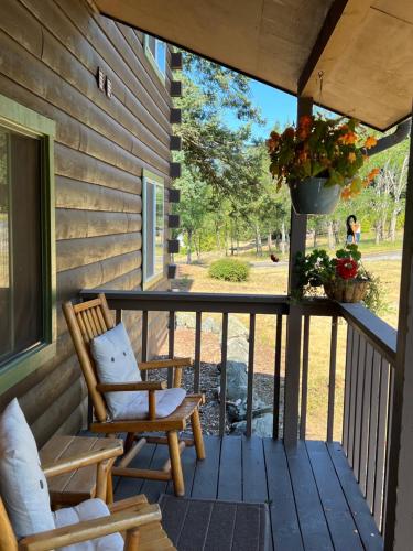 a porch with a rocking chair and a swing at Deer Harbor Inn in Deer Harbor