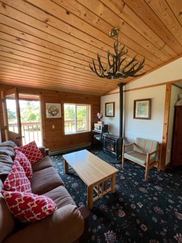 a living room with a couch and a table at Deer Harbor Inn in Deer Harbor