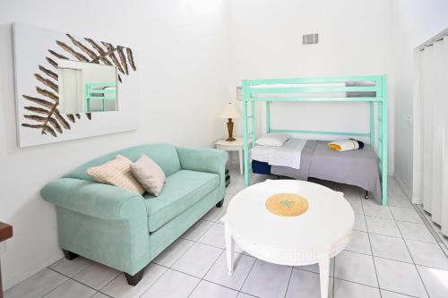 a living room with a couch and a bed at Satellite Beach Townhome with Patios 2 Mi to Beach in Satellite Beach