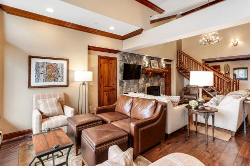 a living room with leather furniture and a fireplace at Lion Square Lodge East 313 in Vail