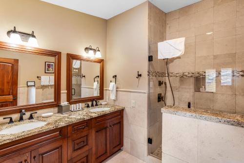 a bathroom with two sinks and a shower at Lion Square Lodge East 313 in Vail