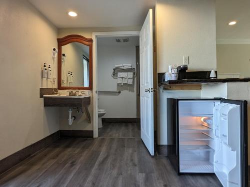 a bathroom with a sink and a refrigerator at Valley Inn in Mission Hills