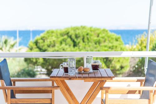 a wooden table with a plate of food on a balcony at Chios BnB in Chios