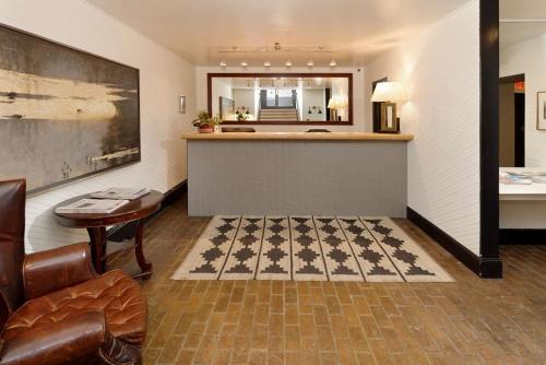 a hotel room with a bar and a checkerboard floor at Independence Square 304, Stylish Hotel Room with Downtown Views & Great Location in Aspen