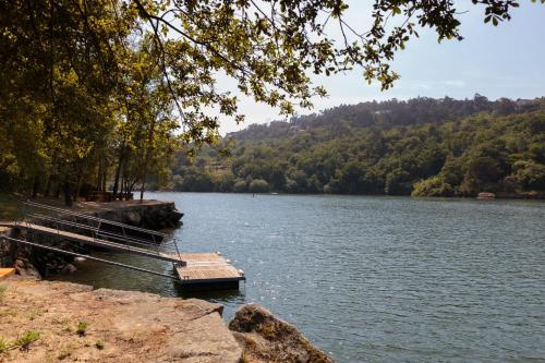 a couple of boats on a lake with trees at Douro Green in Castelo de Paiva