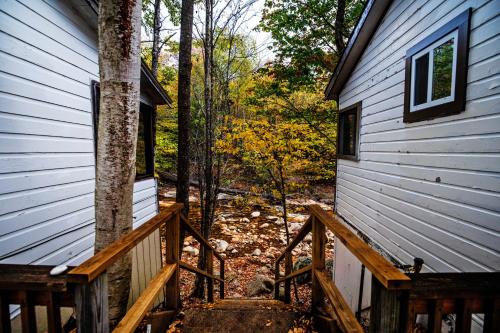 a view from the side of a house with a wooden staircase at Pemi Cabins in Lincoln