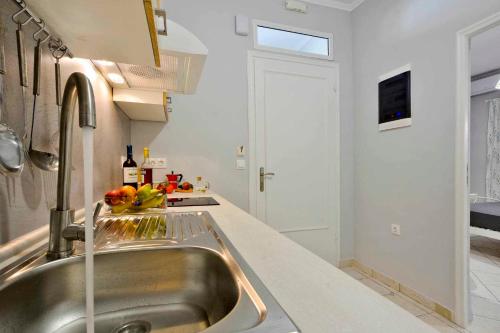 a kitchen with a sink and a counter top at Casa Mia Apartment in Corfu