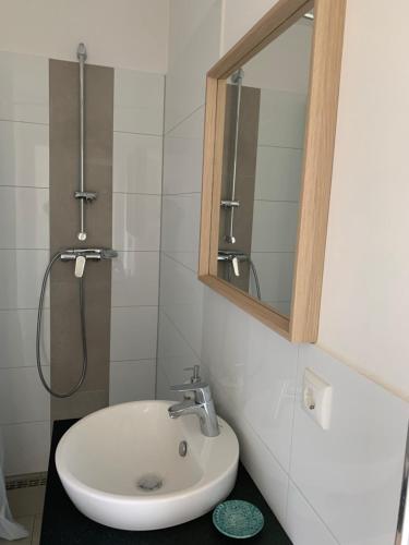 a bathroom with a sink and a mirror at Messe Apartment in Hannover