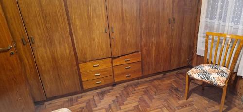 a room with wooden cabinets and a wooden chair at Zarate al Rio in Zárate