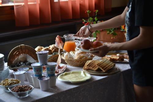 a table with a buffet of breakfast food on it at Hotel Aurora in Colico