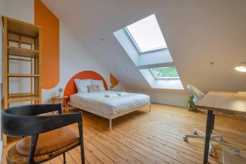 a bedroom with a bed and a skylight at Champagne Sunset in Gueux