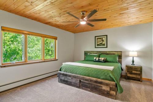 a bedroom with a bed and a ceiling fan at Secluded Mtn home by Purg, Hot Tub, Views! Pets ok in Durango