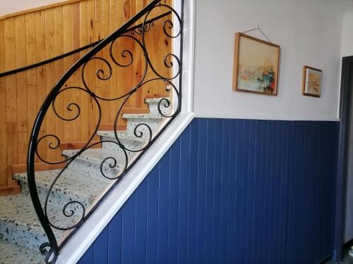 a staircase in a house with a blue wall at Maison du soleil in Prades