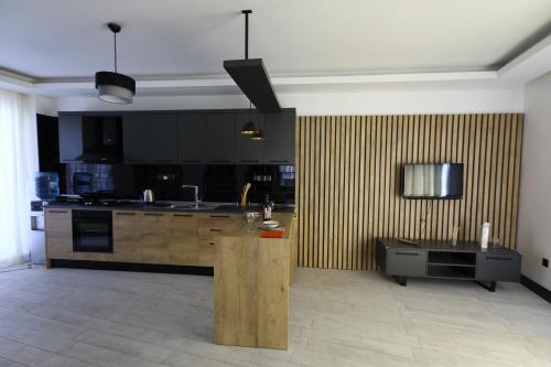 a kitchen with wooden cabinets and a counter in a room at Cyprus Darem Suit sea view, beaches, diving in Kyrenia