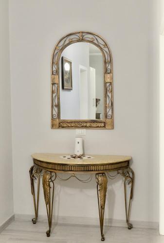 a dressing table with a mirror on a wall at Hotel Vila Dedej in Durrës