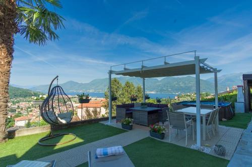 a patio with a table and a swing at Vicolo dei Fiori in Luino
