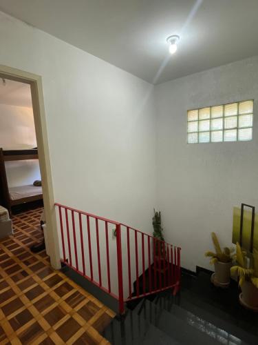 a room with a staircase with a white wall and a window at Quarto privativo ótima localização in São Paulo