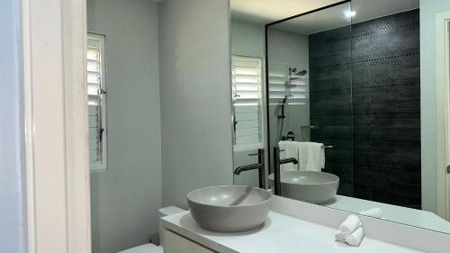 a bathroom with two sinks and a mirror at Jamnick Vacation Rentals - Fern Court, Richmond Estate, St Ann, Jamaica in Ocho Rios
