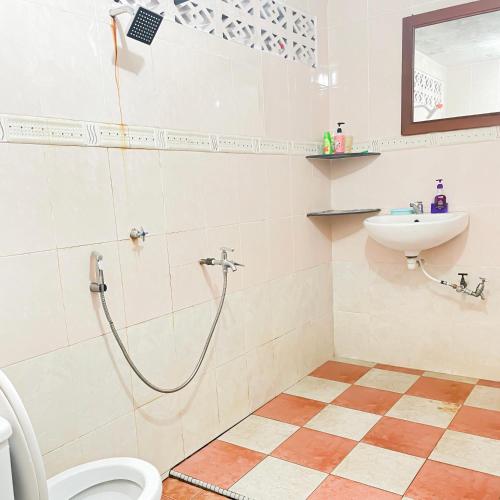 a bathroom with a shower and a toilet and a sink at Dusun Indah Cottage 2 in Bayan Lepas