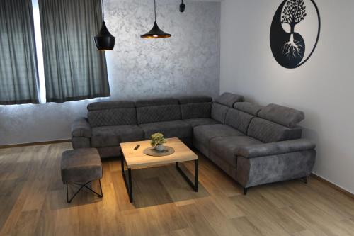a living room with a couch and a table at Avangard HOME II in Rokovci