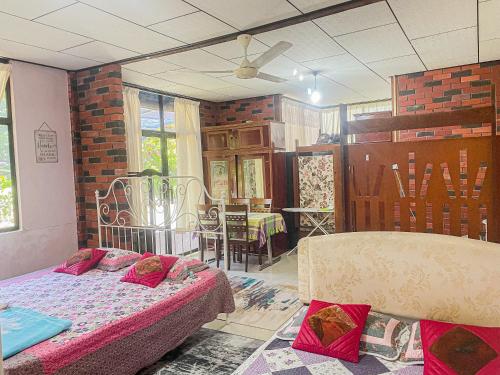 a room with a bed and a dining room at Dusun Indah Cottage 2 in Bayan Lepas