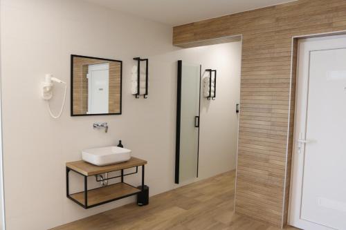 a bathroom with a sink and a mirror at Avangard HOME II in Rokovci