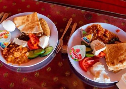 two plates of food sitting on a table with at Milky Way Nights Camp in Wadi Rum