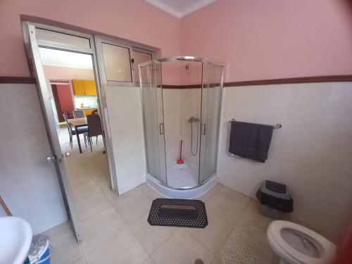a bathroom with a shower and a toilet at Casa Barreto in Tarrafal