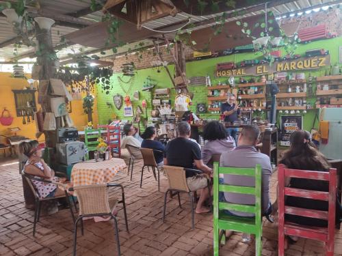 un grupo de personas sentadas en mesas en un restaurante en Hostal El Marquez Pavas, en La Cumbre