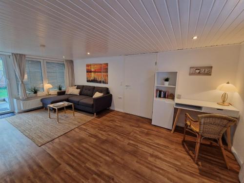 a living room with a couch and a table at Ferienwohnungen Dümmersee - Haus Alter Pferdestall in Hüde