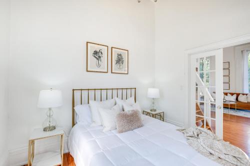 a white bedroom with a large white bed with pillows at Historic New Albany Apartment about 6 Mi to Louisville in New Albany