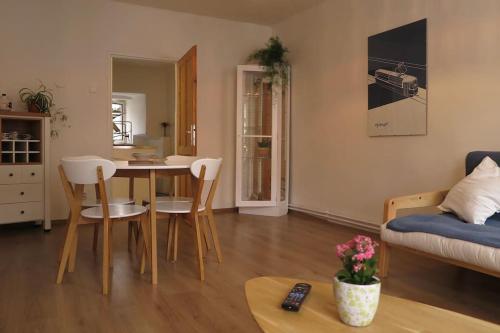 a living room with a table and chairs at Hradčany apartment with green energy in Prague
