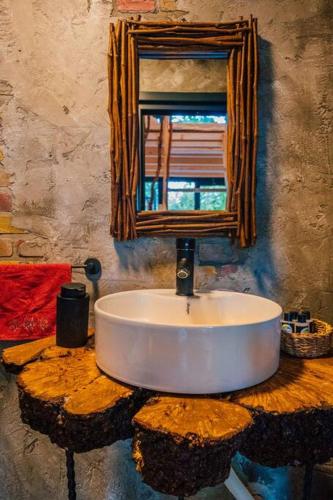 a bathroom with a sink on top of a tree stump at bungalov in Sapanca