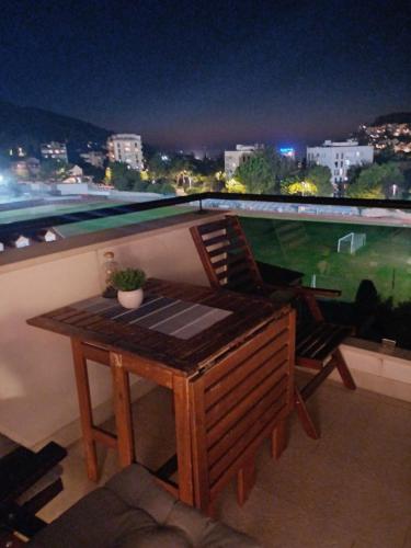 a table and chairs on top of a balcony at night at Apartments Mak & Lux in Dubrovnik