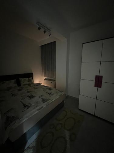 a small bedroom with a bed and a dresser at Apartman Ružica2 in Bijeljina