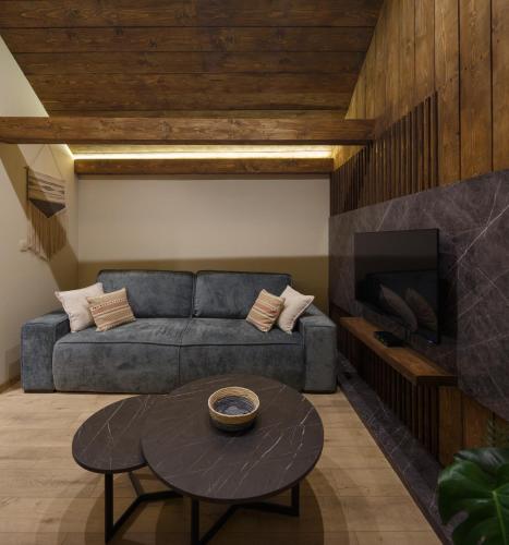 a living room with a couch and a table at Wood cabin Kolasin in Kolašin