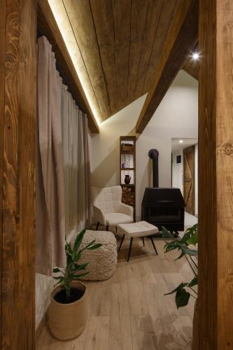 a living room with a couch and a chair at Wood cabin Kolasin in Kolašin