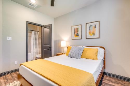 a bedroom with a large bed with yellow sheets at Newly Built Corner Hideaway about 3 Mi to Texas AandM in College Station