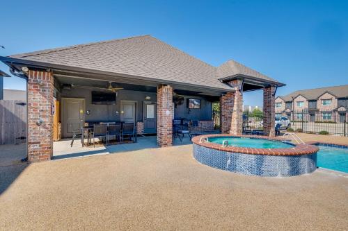 a home with a swimming pool and a house at Newly Built Corner Hideaway 3 Mi to Texas A and M in College Station