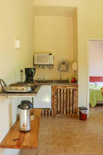 a kitchen with a sink and a counter top at Recanto dos Beija Flores, Chalé lantana a in Monte Alegre do Sul
