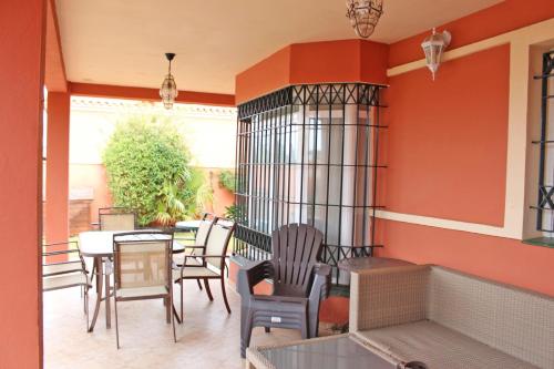 a patio with a table and chairs and a table and chairsktop at Chalet Carlos El Campito in Chiclana de la Frontera