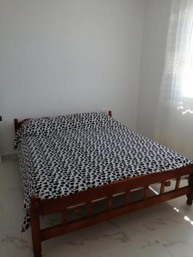 a bed with a black and white mattress at Bujtinat Peci in Elbasan